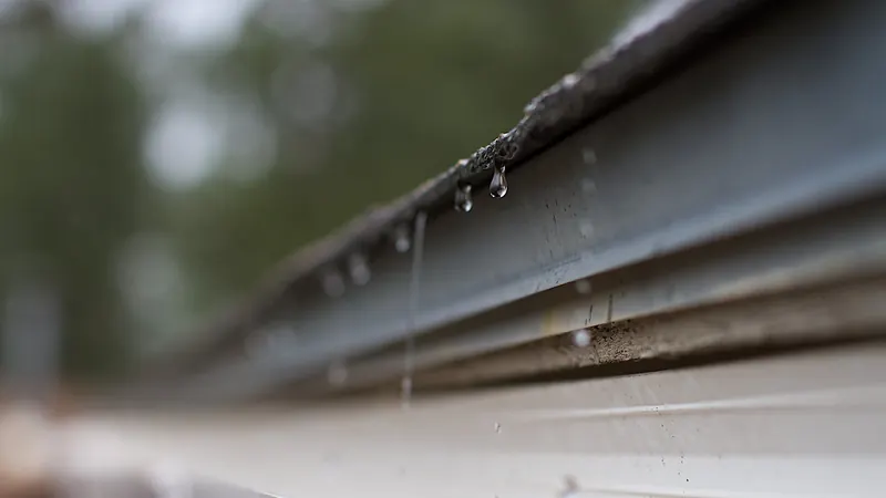 Water droplets along the edge of a gutter