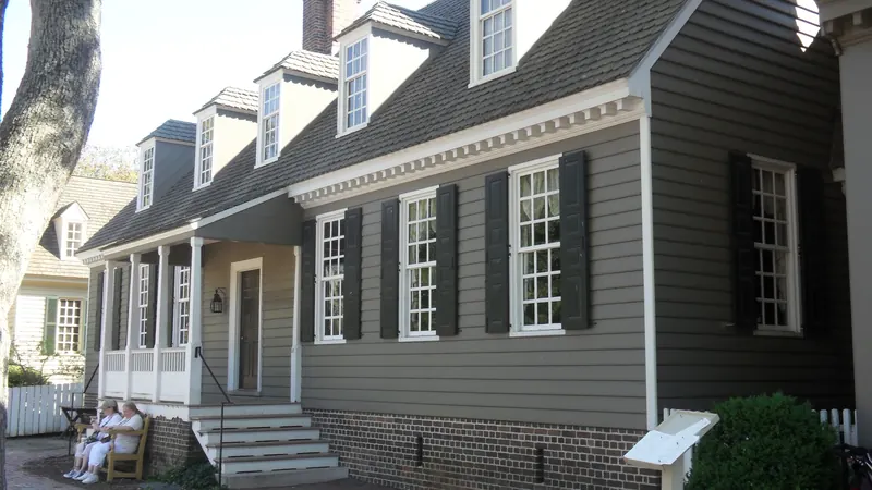 Two-story colonial-style house with dormers and a long gutter run